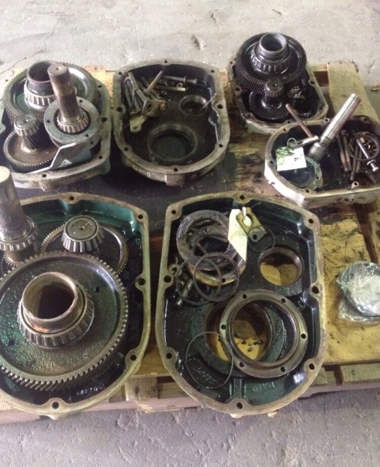 Gearbox housings and gear sets laid out during teardown and inspection