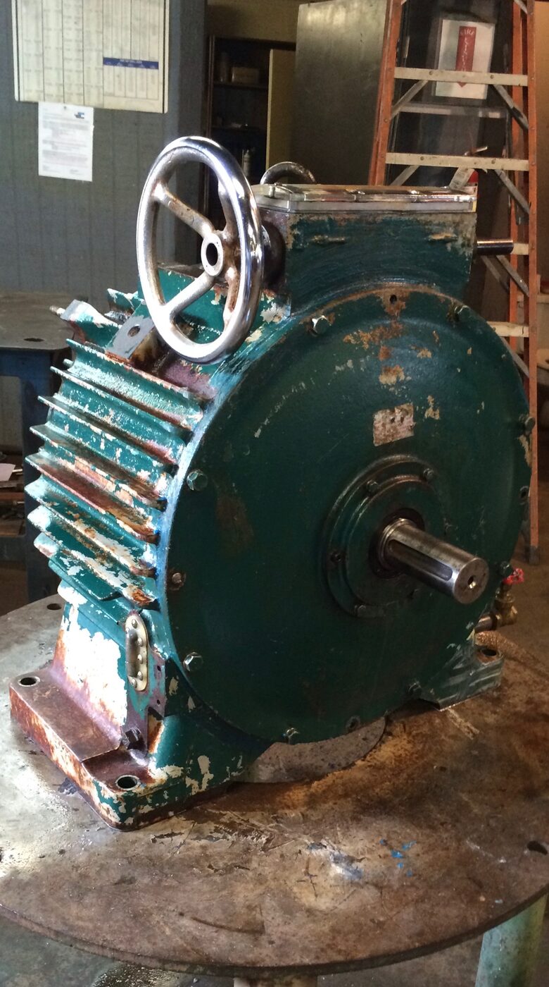 A rebuilt green gearbox with a handwheel and cooling fins