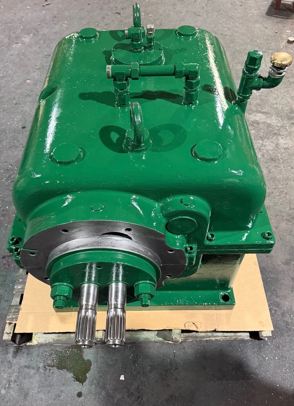 A rebuilt green gearbox showing its machined output shafts