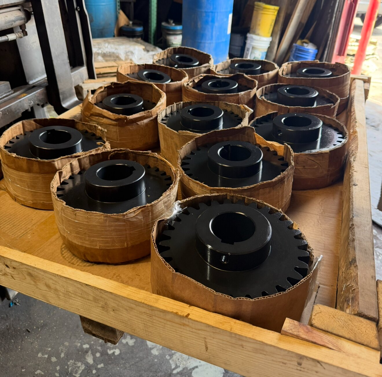 Reconditioned coupling blocks and a hardened gear hub staged on a pallet in the Solution Gear Houston shop