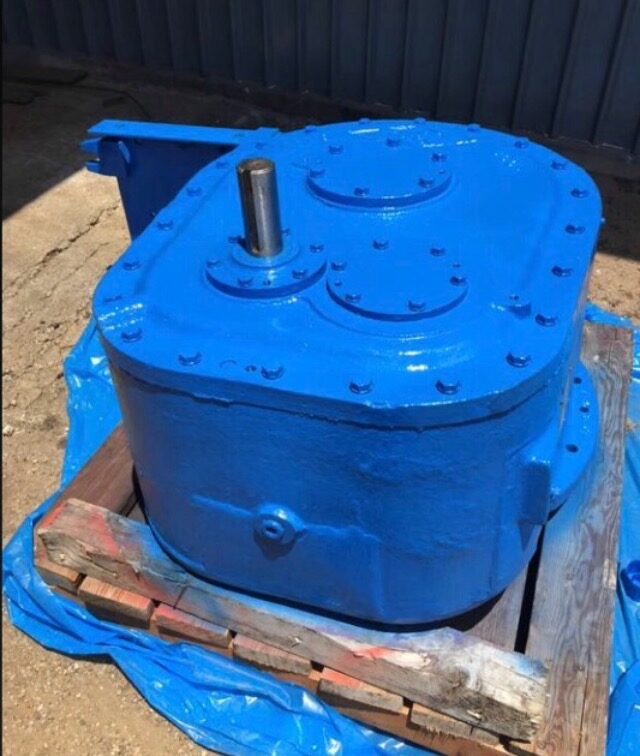 A rebuilt industrial gearbox, repainted and crated for shipment