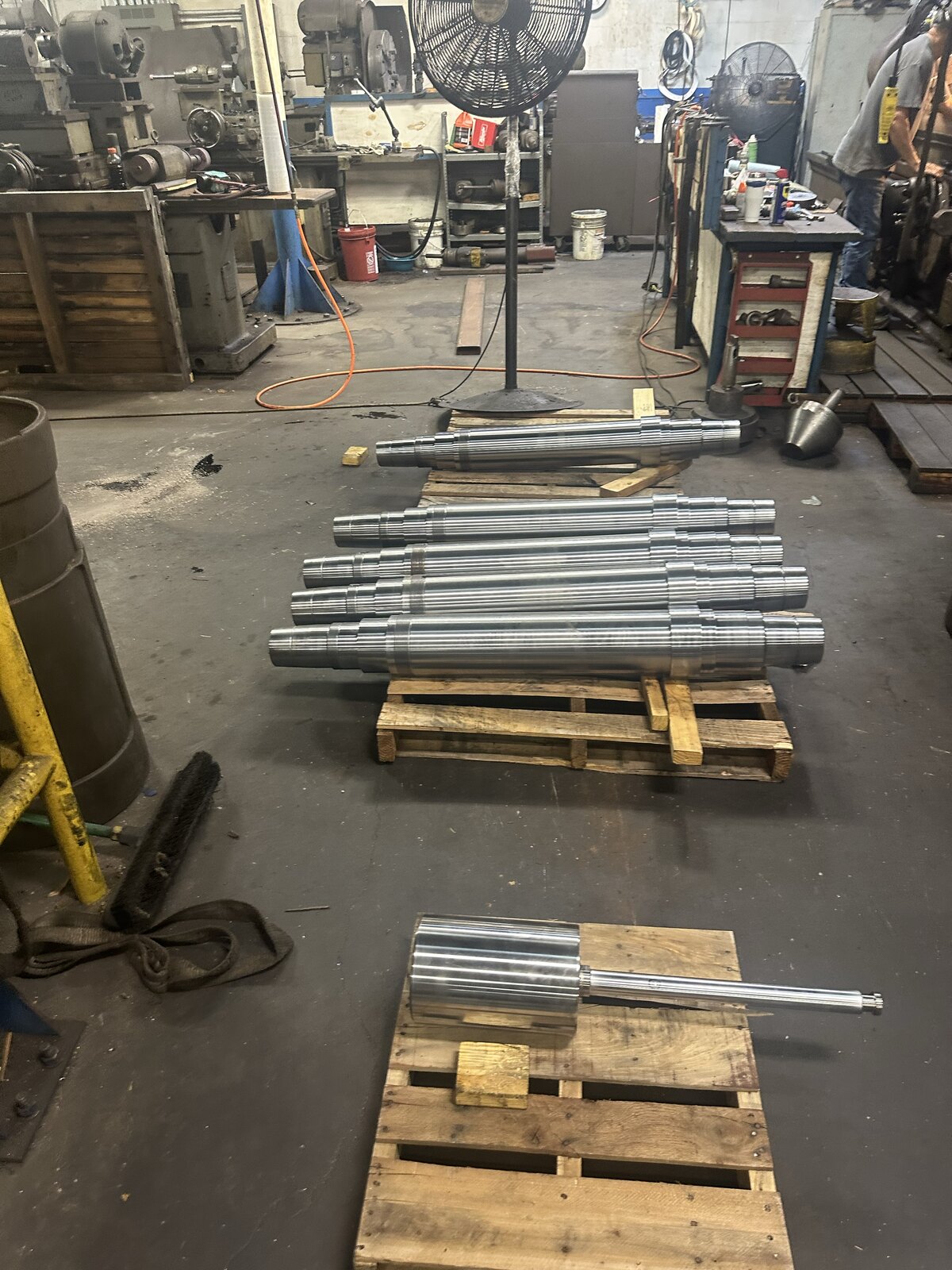 Remachined rolls and drive shafts staged on pallets